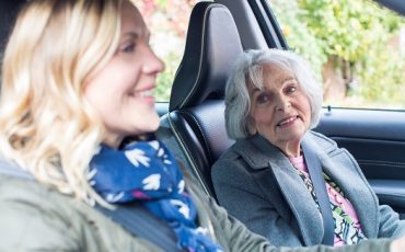 Female Neighbor Giving Senior Woman A Lift In Car